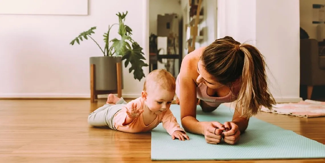 Postpartum mom doing gentle exercise at home with baby at three months postpartum