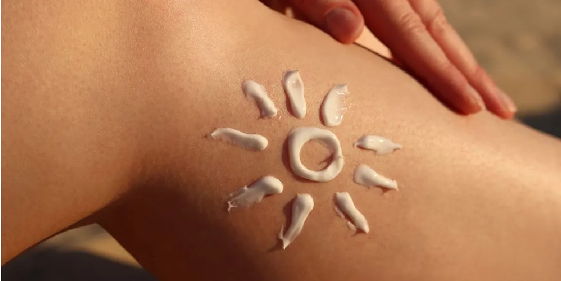 Sunscreen applied to skin in sun shape showing how much sunscreen is needed for effective SPF protection.webp