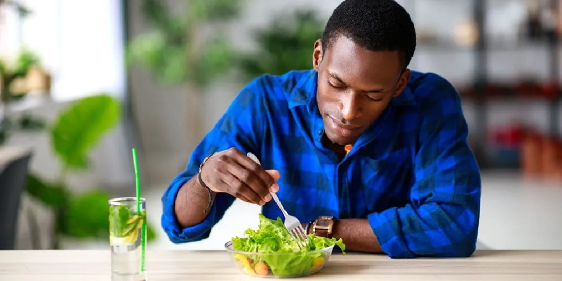 Man eating healthy salad for men's nutrition and wellness