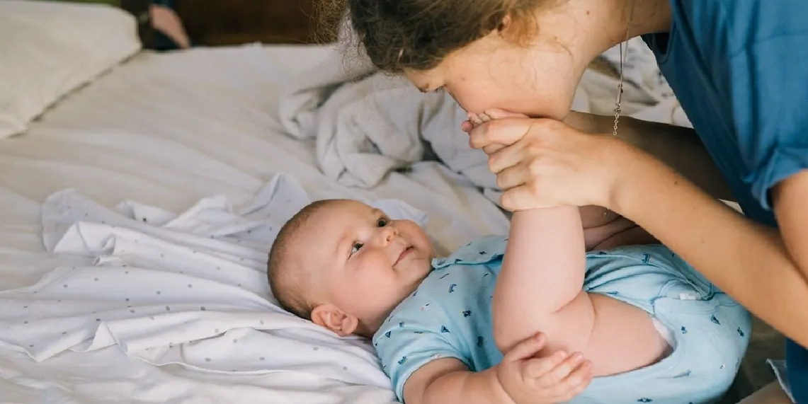 Mom connecting with comfortable alert baby showing normal infant digestion and contentment