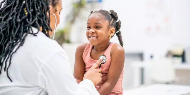 Checking vital signs during a back-to-school well child visit