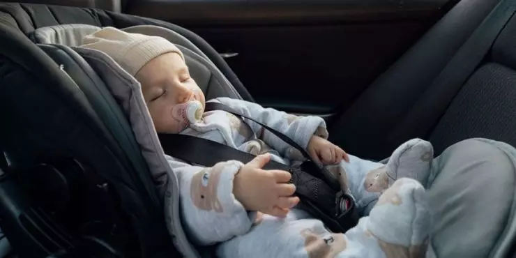 Baby sleeping in car seat while traveling