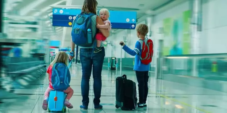 Family traveling with young children at airport