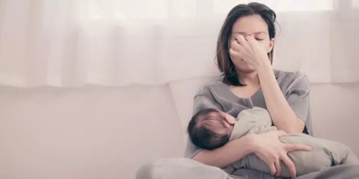 Image3-tired-mom-holding-baby-postpartum-stress.jpg
