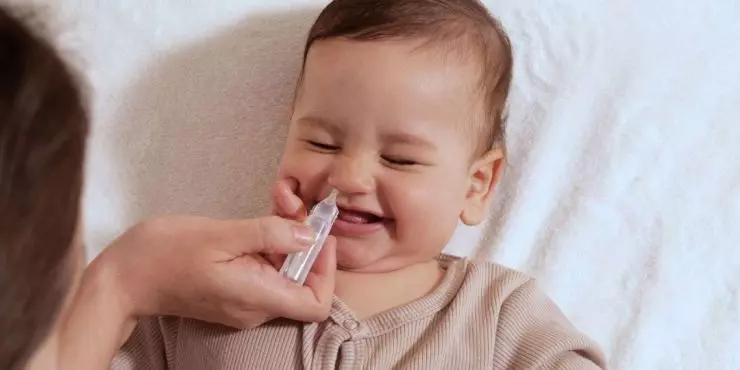 Saline drops helping clear baby’s stuffy nose
