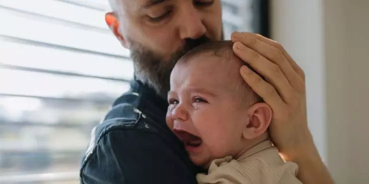 Dad-comforting-a-fussy-crying-baby-during-a-growth-spurt-or-developmental-leap.jpg
