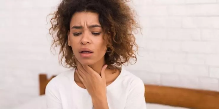 Woman with sore throat discomfort