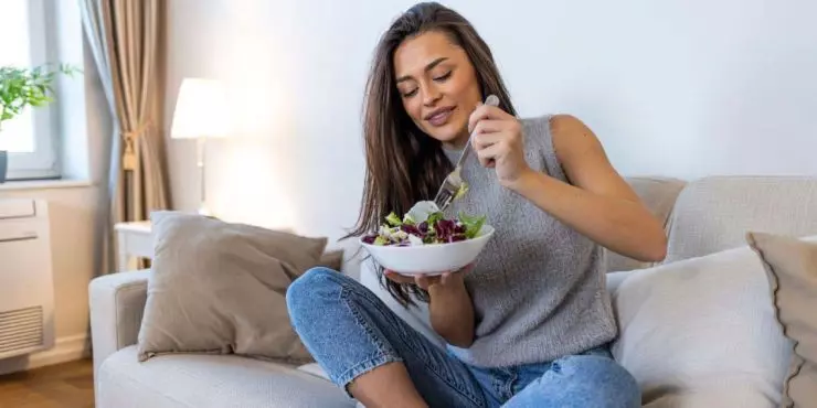 _Woman-eating-a-fresh-salad-at-home-as-part-of-a-spring-nutrition-reset.jpg