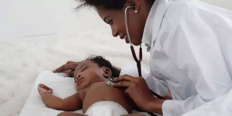 Doctor examining baby for chest congestion