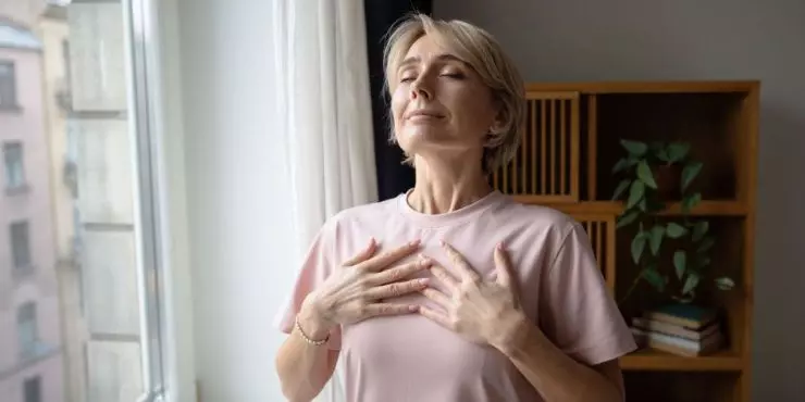 Person practicing deep breathing for stress relief