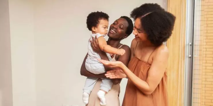 Mom having another woman help with her baby