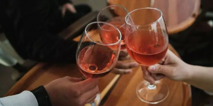 Woman being mindful of alcohol consumption cheersing