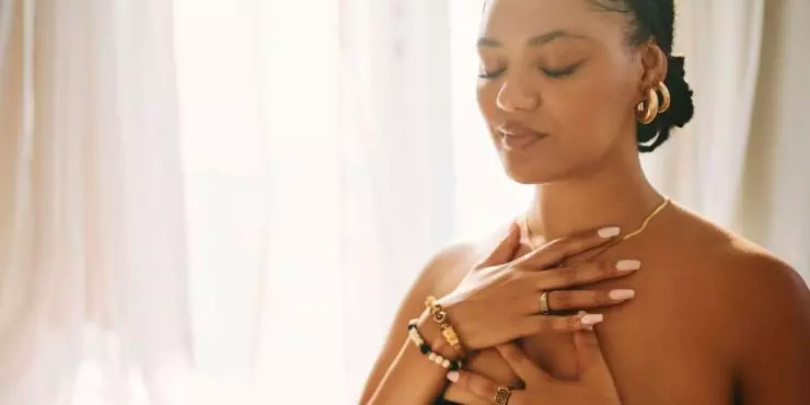 Woman doing postpartum breathing exercise