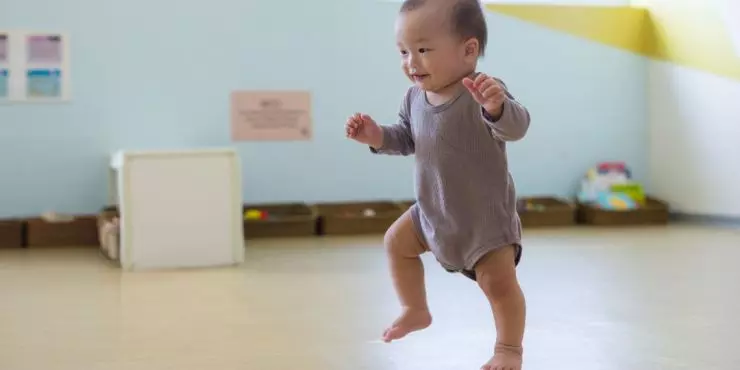 Baby reaching the milestone of taking first steps