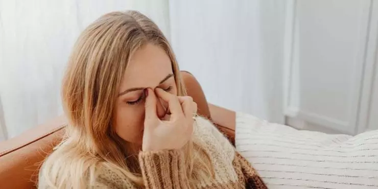 Woman-pressing-sinuses-experiencing-facial-pressure-from-cold-or-allergies.jpg