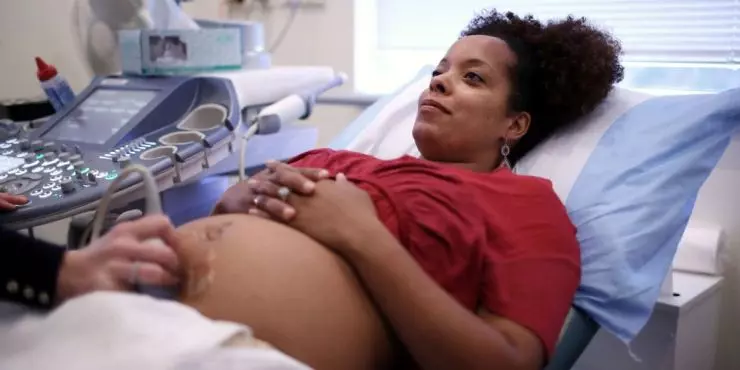 Pregnant woman having ultrasound at prenatal care appointment