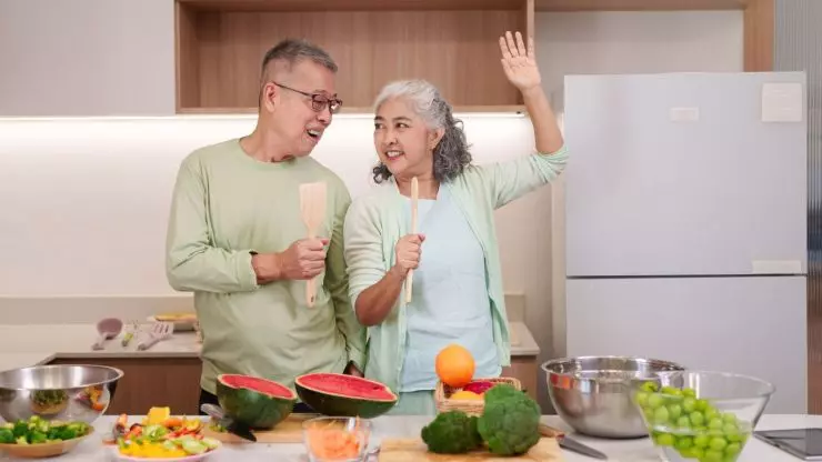 Older couple cooking a nutritious meal together to support healthy aging