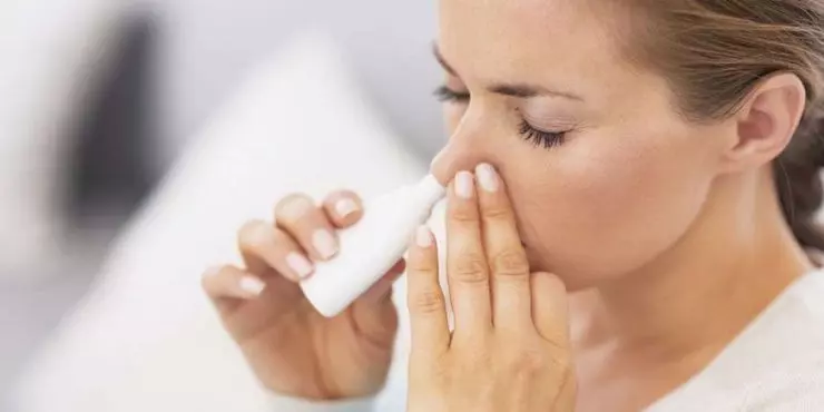 Woman-using-nasal-spray-to-treat-sinus-pressure-and-congestion.jpg
